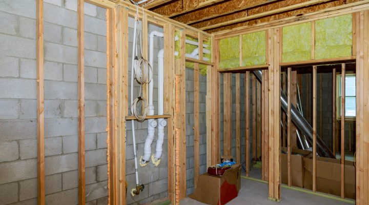 Basement reconstruction; structure shows wood framing, plumbing system for drainage