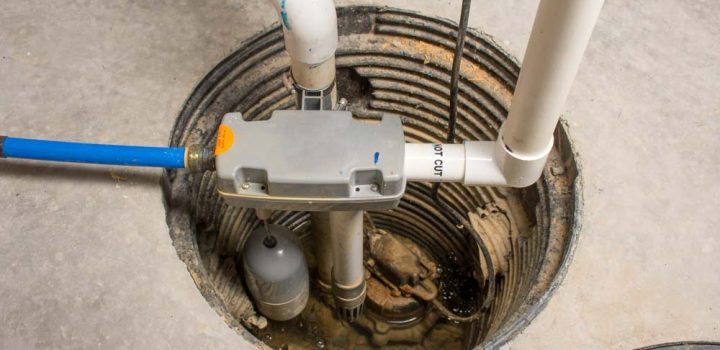 A sump pump installed in the basement of a home with a water-powered backup system