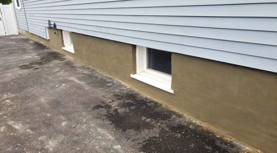 New Parging of Exterior Basement Wall: coating cement on a concrete block