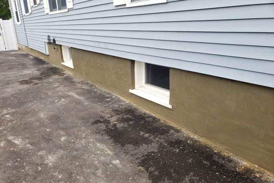 New Parging of Exterior Basement Wall: coating cement on a concrete block